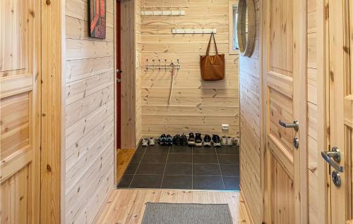 a walk in shower in a wooden cabin with a door at Cozy Home In Vikes With House A Mountain View in Vikeså
