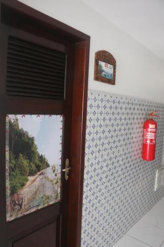 a door with a window with a view of a beach at Pousada Maramazon in São Luís