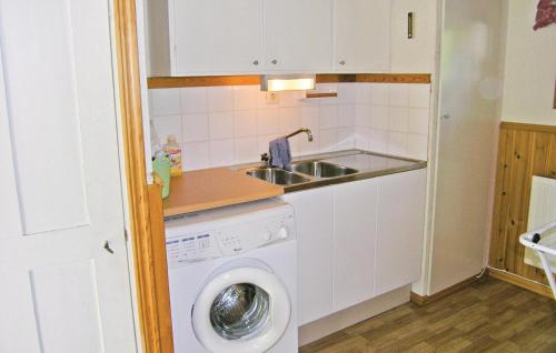 uma cozinha com um lavatório e uma máquina de lavar roupa em Awesome Home In Bottnaryd With 3 Bedrooms And Wifi em Bottnaryd