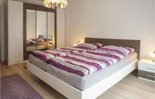 a large bed in a bedroom with a mirror at Awesome Apartment In Hornberg With 2 Bedrooms And Wifi in Hornberg