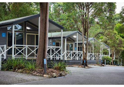 a house with a fence and trees at Discovery Parks - Lane Cove in Sydney