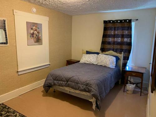 a bedroom with a bed in the corner of a room at 3 bedroom one bathroom townhouse - 20B Elm street Charlton Heights WV 25040 in Glen Ferris