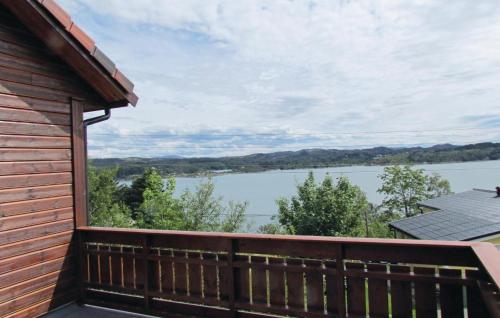 a balcony with a view of a lake at Awesome Home In Kolnes in Eike