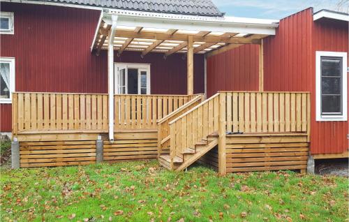 a wooden deck on a house with a pergola at 2 Bedroom Cozy Home In Kosta in Kosta