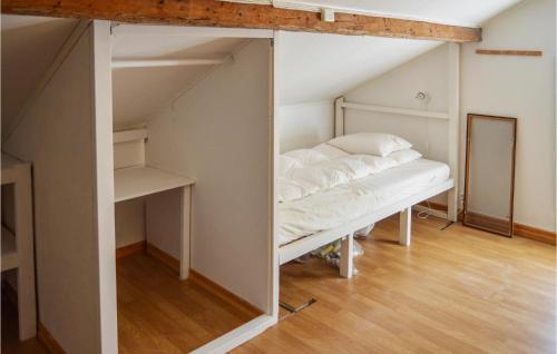 a room with a bed and a mirror at Stunning Home In Vstervik With Kitchen in Västervik