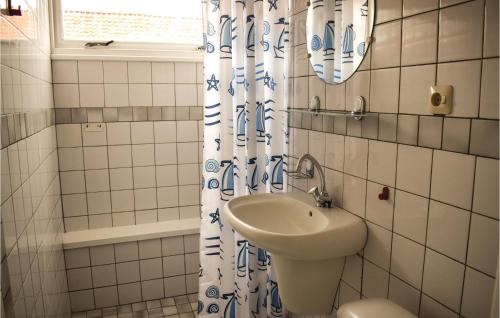 a bathroom with a sink and a shower curtain at De Eekhof - Appartement 7 in Hindeloopen