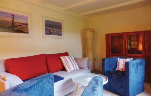 a living room with a couch and two blue chairs at Amazing home in Crinitzberg with 1 Bedrooms and WiFi in Bärenwalde