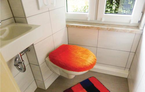 a bathroom with a toilet with a colorful seat at 1 Bedroom Nice Home In Crinitzberg in Bärenwalde