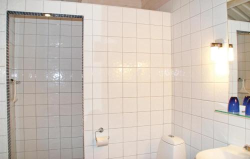 a bathroom with a toilet and a glass shower door at Cozy Home In Sälen With Sauna in Stöten