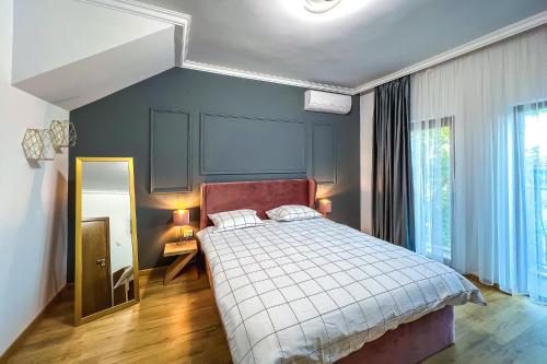 um quarto com uma cama grande e um espelho em Deluxe Central Rooms em Karlovo