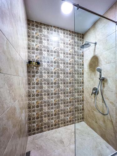 a bathroom with a shower with a glass door at Deluxe Central Rooms in Karlovo