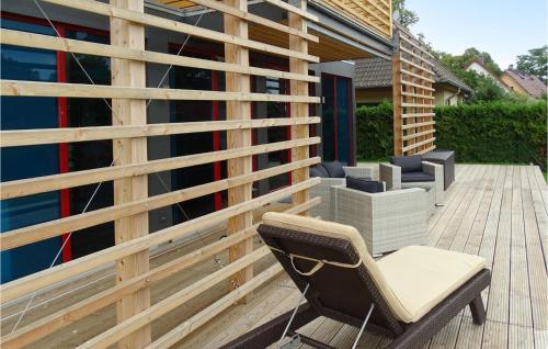 a chair sitting on a deck next to a building at Haus 8 in Wendorf