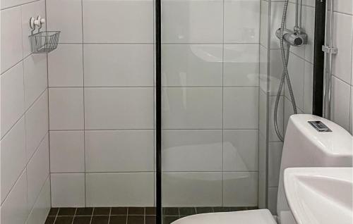 a bathroom with a shower with a toilet and a sink at Cozy Home In Vemdalen With Sauna in Vemdalen