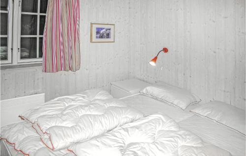 a white bed in a room with a lamp at Awesome Home In Gl With Sauna in Gålå