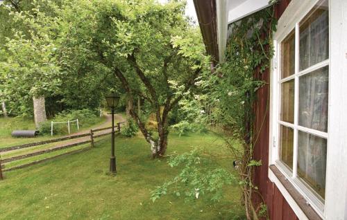a window of a house with a tree and a street light at 2 Bedroom Cozy Home In Sjötorp in Sjötorp