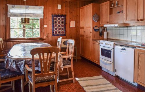 a kitchen with a table and a white stove top oven at Trollstua in Asak