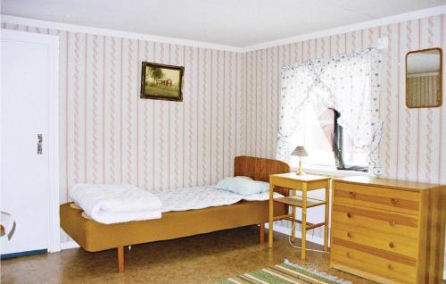 LinnerydにあるBeautiful Home In Linneryd With Kitchenのベッドルーム1室(ベッド1台、デスク、ドレッサー付)