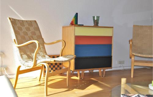 a room with two chairs and a colorful cabinet at De Trapjes in Bergen aan Zee