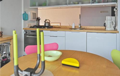 a kitchen with a table with baseball mitts on it at De Trapjes in Bergen aan Zee