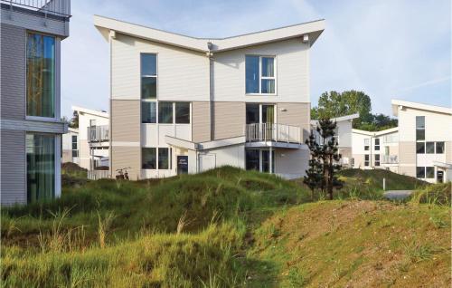 a house on top of a grassy hill at Dünenvilla 20, Whg 2 in Travemünde