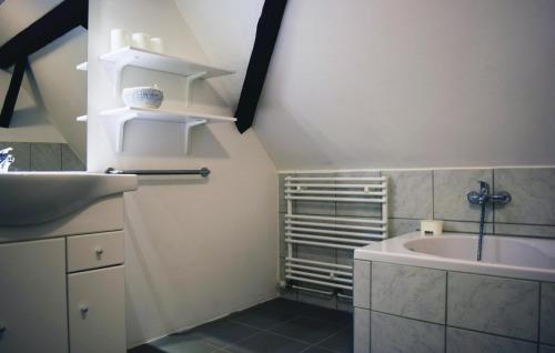 a bathroom with a sink and a bath tub at Awesome Apartment In Bad Berleburg-bergh, With 2 Bedrooms And Wifi in Bad Berleburg