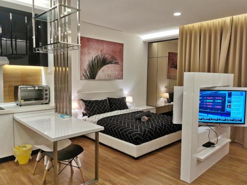 a bedroom with a bed and a desk with a computer at Apple 5 @ Menara Simfoni/Symphony Tower Free Wifi/Parking/TV Box/Nexflix in Cheras