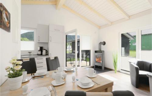 a white living room with a table and a fireplace at Ferienhausdorf Thale in Thale