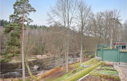 a house with a hose next to a river at Beautiful Home In Svängsta With Sauna in Svängsta