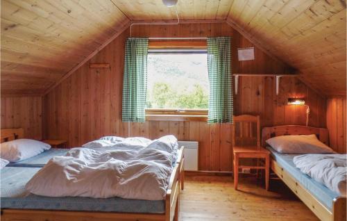 a bedroom with two beds in a wooden house at Bassebu-updalstl in Tyinkrysset
