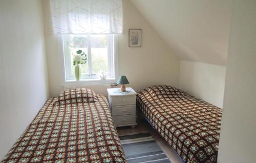 A bed or beds in a room at Lovely Home In Knred With Lake View