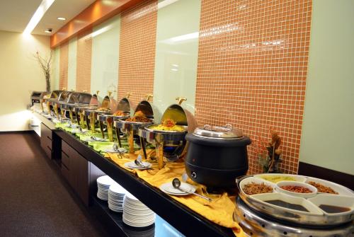 a long table with many plates of food on it at Hotel Sentral KL @ KL Sentral Station in Kuala Lumpur