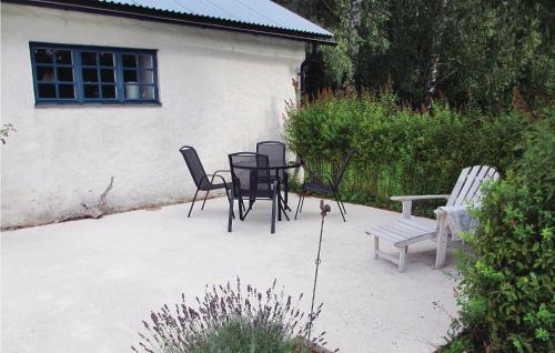 a patio with chairs and a table and a bench at Nice Home In Visby With Wifi in Endre