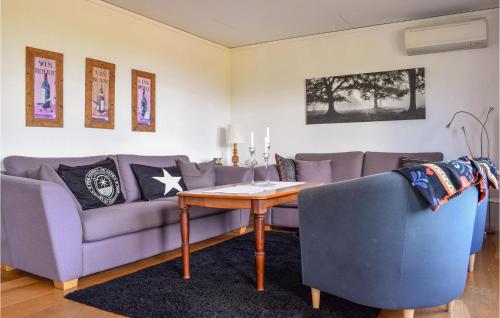 a living room with a couch and a table at Stunning Apartment In Vetlanda in Vetlanda