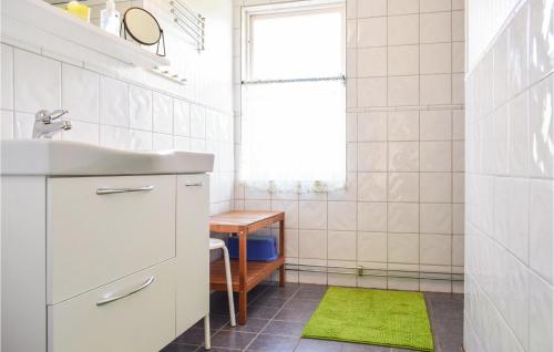 a bathroom with a sink and a green rug at 2 Bedroom Pet Friendly Apartment In Vetlanda in Vetlanda