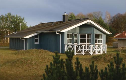 a small blue house on a grass field at Meeresrauschen 3 - Dorf 6 in Priwall