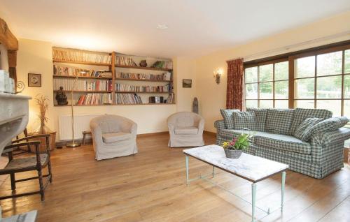 a living room with a couch and chairs and a table at La Maison D'albertine in Briscol