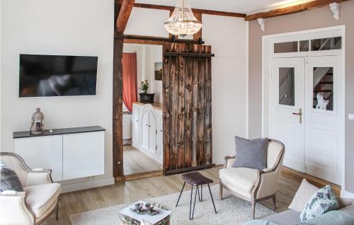 a living room with a couch and chairs and a mirror at Wendischer Hof in Wendisch Evern