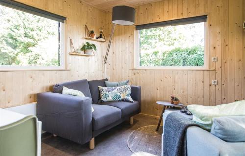 a living room with a couch and two windows at Pet Friendly Home In Bruchterveld in Bruchterveld