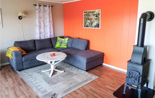 a living room with a couch and a stove at 2 Bedroom Gorgeous Home In Sveio in Sveio