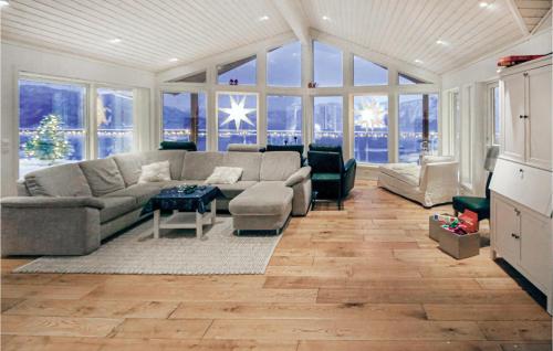 a living room with a couch and a table at 4 Bedroom Awesome Home In Farsund in Herad