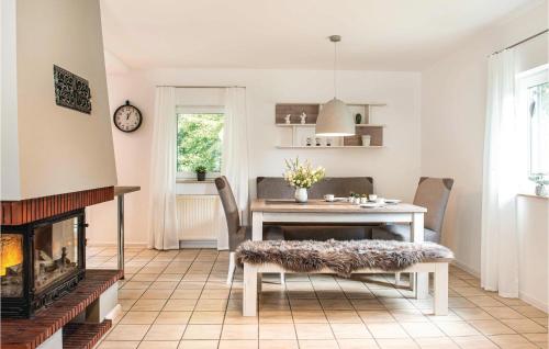 a dining room with a table and a fireplace at Ferienhaus 19 In Thalfang in Thalfang