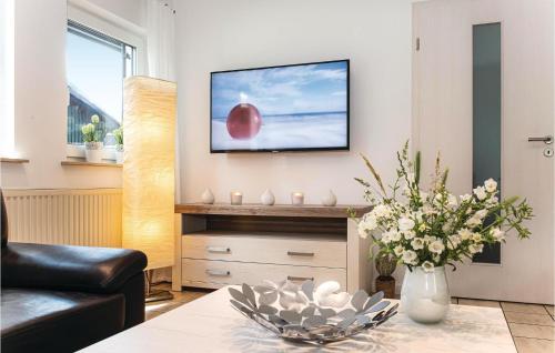 a living room with a television on a wall at Ferienhaus 19 In Thalfang in Thalfang