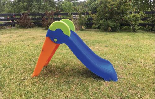 a plastic toy dinosaur is on the grass at Nice Home In Gunnebo With Wifi in Västervik