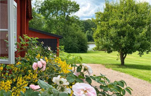 a garden of flowers next to a house at Cozy Home In Mantorp With Wifi in Mantorp