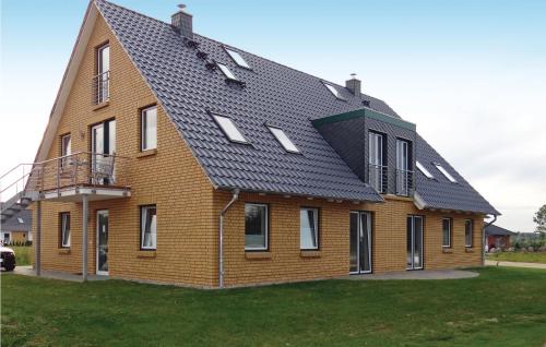 a house with a black roof on top of a yard at Fewo Schloss Bothmer in Kaschow