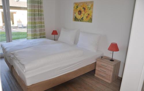 a bedroom with a bed with a night stand and a window at Fewo Schloss Bothmer in Kaschow