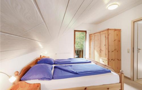 a bedroom with a large bed with blue pillows at Ferienhaus 14 In Kirchheim in Kemmerode
