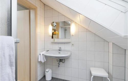 a white bathroom with a sink and a toilet at Ferienhaus 14 In Kirchheim in Kemmerode