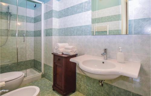 a bathroom with a sink and a toilet and a shower at Villetta Solanum in Viareggio