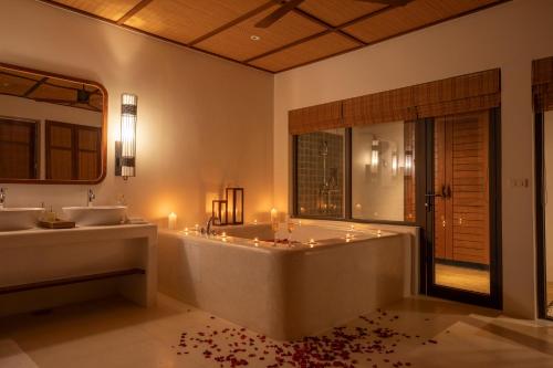 a bathroom with a tub and two sinks and a bath tub at The Royal Sands Koh Rong in Koh Rong Island